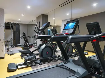 a gym with several tread machines and a treadmill at NYX Esperia Palace Hotel Athens by Leonardo Hotels in Athens