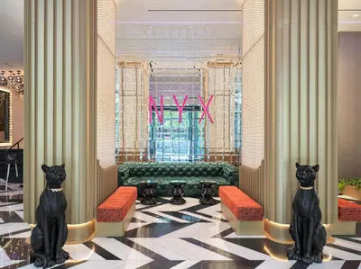 a lobby with two black cats sitting in a room at NYX Esperia Palace Hotel Athens by Leonardo Hotels in Athens