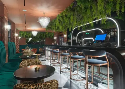 a bar with stools and a laptop on the counter at NYX Esperia Palace Hotel Athens by Leonardo Hotels in Athens