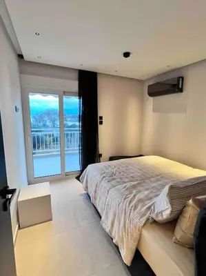 a bedroom with a large bed and a large window at Lagonisi 2 bedroom luxury Apartment by the sea! in Lagonissi