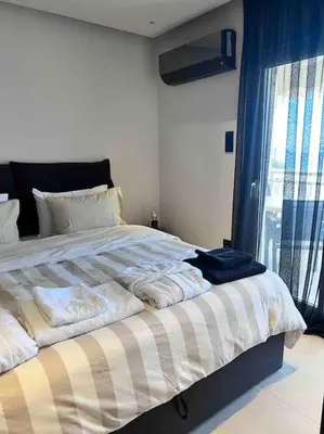 a bedroom with a bed with towels on it at Lagonisi 2 bedroom luxury Apartment by the sea! in Lagonissi