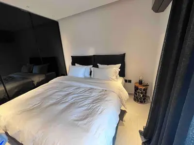 a bedroom with a large bed with white sheets and pillows at Lagonisi 2 bedroom luxury Apartment by the sea! in Lagonissi