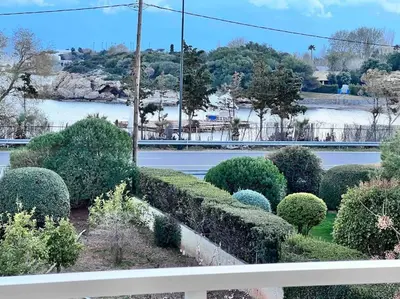 a view of a garden with bushes and a river at Lagonisi 2 bedroom luxury Apartment by the sea! in Lagonissi