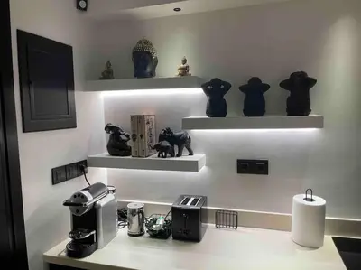 a room with shelves with figurines on a counter at Lagonisi Luxury apartment 2 by the sea in Lagonissi