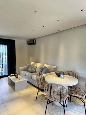 a living room with a couch and a table at Lagonisi Luxury apartment 2 by the sea in Lagonissi