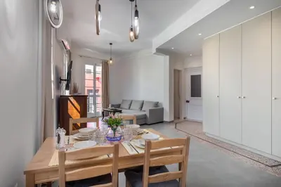 a dining room and living room with a table and chairs at Christiana's lovely apartment in Psyri, Athens in Athens