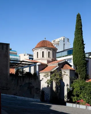 a building with a tower with a tile roof at Christiana's lovely apartment in Psyri, Athens in Athens