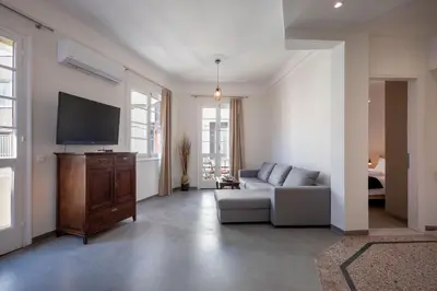 a living room with a couch and a flat screen tv at Christiana's lovely apartment in Psyri, Athens in Athens