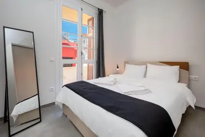 a bedroom with a large bed and a mirror at Christiana's lovely apartment in Psyri, Athens in Athens