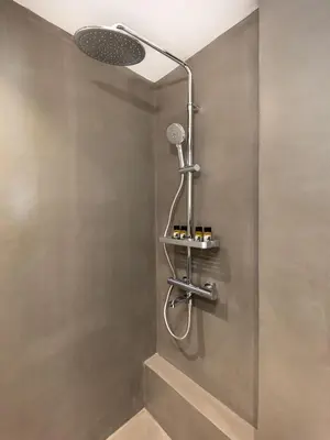 a shower with a shower head and a microphone at Christiana's lovely apartment in Psyri, Athens in Athens