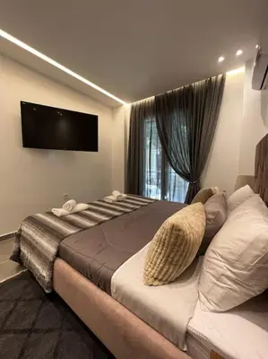 a bedroom with a large bed and a television at Studio MV in the center of Athens - Secured area in Athens