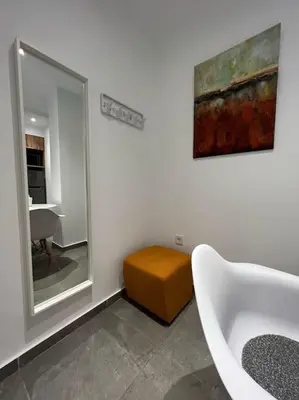 a bathroom with a sink and a mirror and a stool at Studio MV in the center of Athens - Secured area in Athens