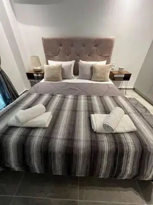 a bedroom with a large bed with pillows on it at Studio MV in the center of Athens - Secured area in Athens