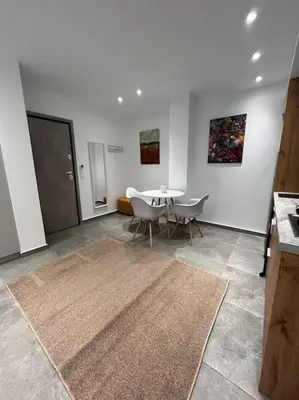 a room with a table and chairs and a rug at Studio MV in the center of Athens - Secured area in Athens