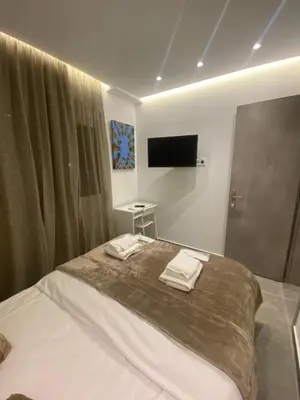 a bedroom with a bed with two towels on it at Studio MV in the center of Athens - Secured area in Athens