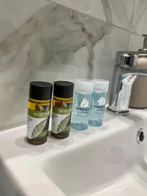 three bottles of cleaning products sitting on top of a sink at Studio MV in the center of Athens - Secured area in Athens