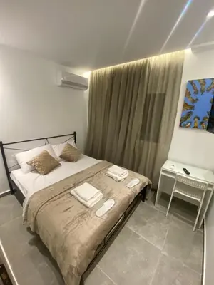 a bedroom with a bed with two towels on it at Studio MV in the center of Athens - Secured area in Athens