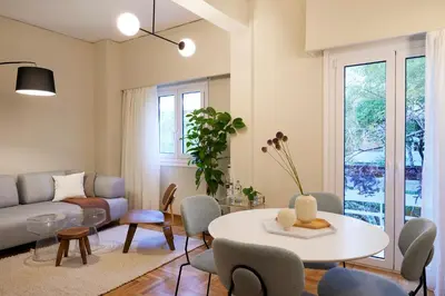 a living room with a table and a couch at Phaedrus Living Kolonaki Crown Residences in Athens