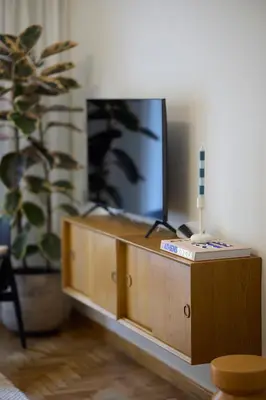 a wooden entertainment center with a flat screen tv at Phaedrus Living Kolonaki Crown Residences in Athens