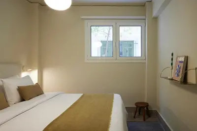 a bedroom with a bed and a window at Phaedrus Living Kolonaki Crown Residences in Athens