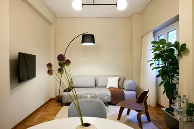a living room with a couch and a table at Phaedrus Living Kolonaki Crown Residences in Athens