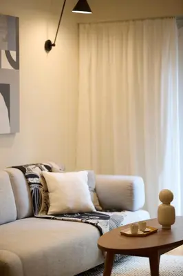 a living room with a couch and a table at Phaedrus Living Kolonaki Crown Residences in Athens