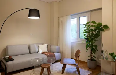 a living room with a couch and a table at Phaedrus Living Kolonaki Crown Residences in Athens