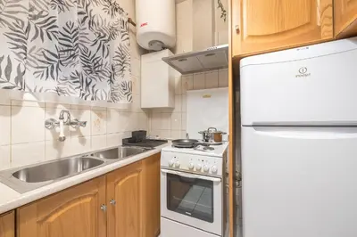a kitchen with a sink and a white refrigerator at Athens City Getaway in Athens