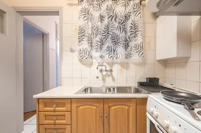 a kitchen with a sink and a shower curtain at Athens City Getaway in Athens