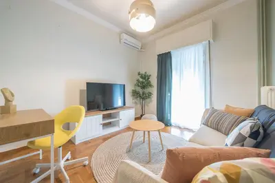 a living room with a couch and a table at Athens City Getaway in Athens