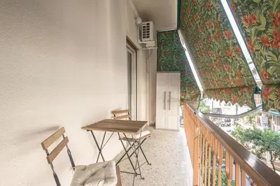 a balcony with two chairs and a table on a building at Athens City Getaway in Athens