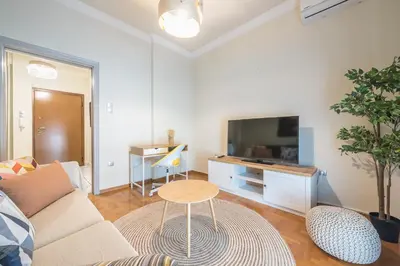 a living room with a couch and a table at Athens City Getaway in Athens