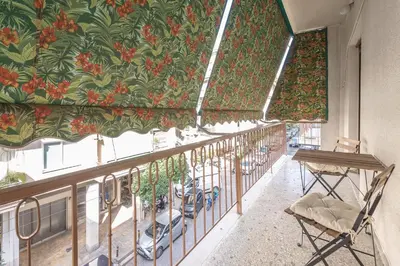 a balcony with a mural of flowers on the wall at Athens City Getaway in Athens