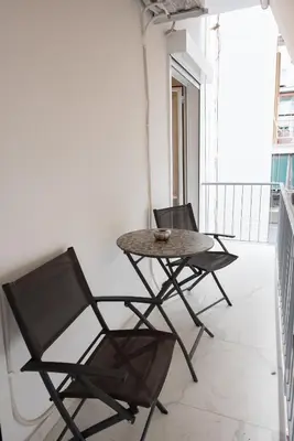two chairs and a table on a balcony at MEDLUXE COZY APARTMENT! in Athens