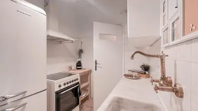 a white kitchen with a stove and a sink at Boho Chic 2BR Apartment in the Center of Athens in Athens