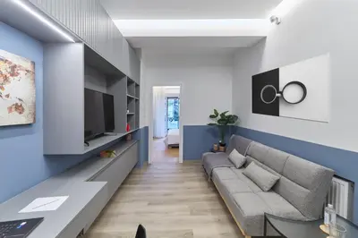 a living room with a couch and a tv at Artemis Suite at Acropolis Historic Center in Athens