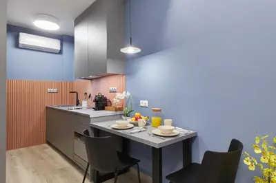 a kitchen with a table and chairs in a room at Artemis Suite at Acropolis Historic Center in Athens