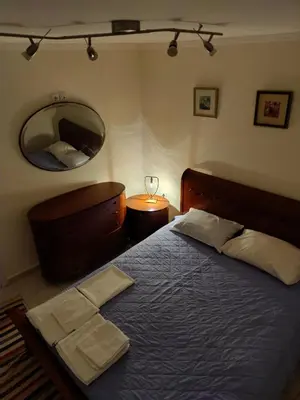 a bedroom with a large bed and a mirror at Friends Apartment Syngrou in Athens