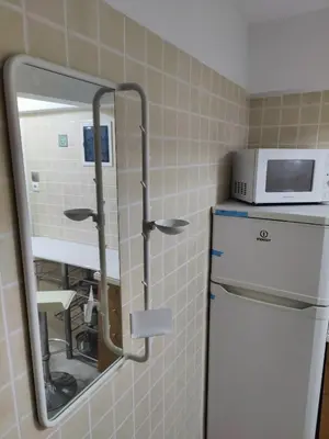 a kitchen with a microwave and a refrigerator at Friends Apartment Syngrou in Athens