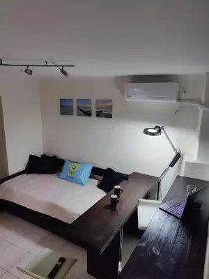 a bedroom with a bed and a desk with a lamp at Friends Apartment Syngrou in Athens
