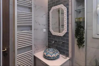 a bathroom with a sink and a mirror at Artistic apt in vibrant Gazi with large terrace by GHH in Athens