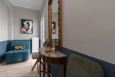 a living room with a table and a mirror at Artistic apt in vibrant Gazi with large terrace by GHH in Athens