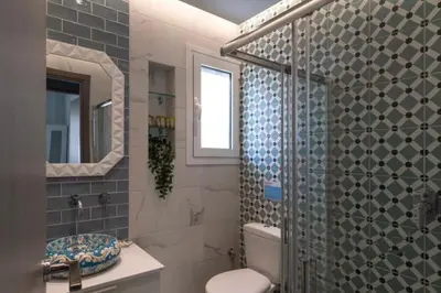 a bathroom with a shower and a toilet and a sink at Artistic apt in vibrant Gazi with large terrace by GHH in Athens