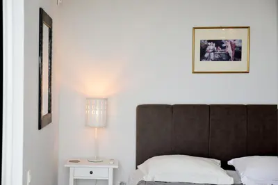 a bedroom with a bed and a lamp on a table at Athens Edem Beach Penthouse, panoramic sea view in Athens