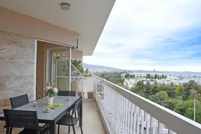 a balcony with a table and chairs and a view at Athens Edem Beach Penthouse, panoramic sea view in Athens