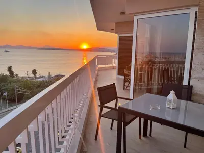 a balcony with a table and a view of the ocean at Athens Edem Beach Penthouse, panoramic sea view in Athens