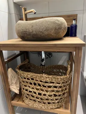 a stone sink on a wooden shelf with a basket at Boho Privet Flat in Athens in Athens
