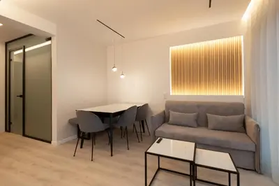 a living room with a couch and a table at Incanto Boutique Suites - Neos Kosmos in Athens
