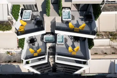 an aerial view of a building with yellow chairs at Incanto Boutique Suites - Neos Kosmos in Athens