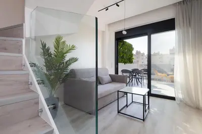 a living room with a couch and a table at Incanto Boutique Suites - Neos Kosmos in Athens